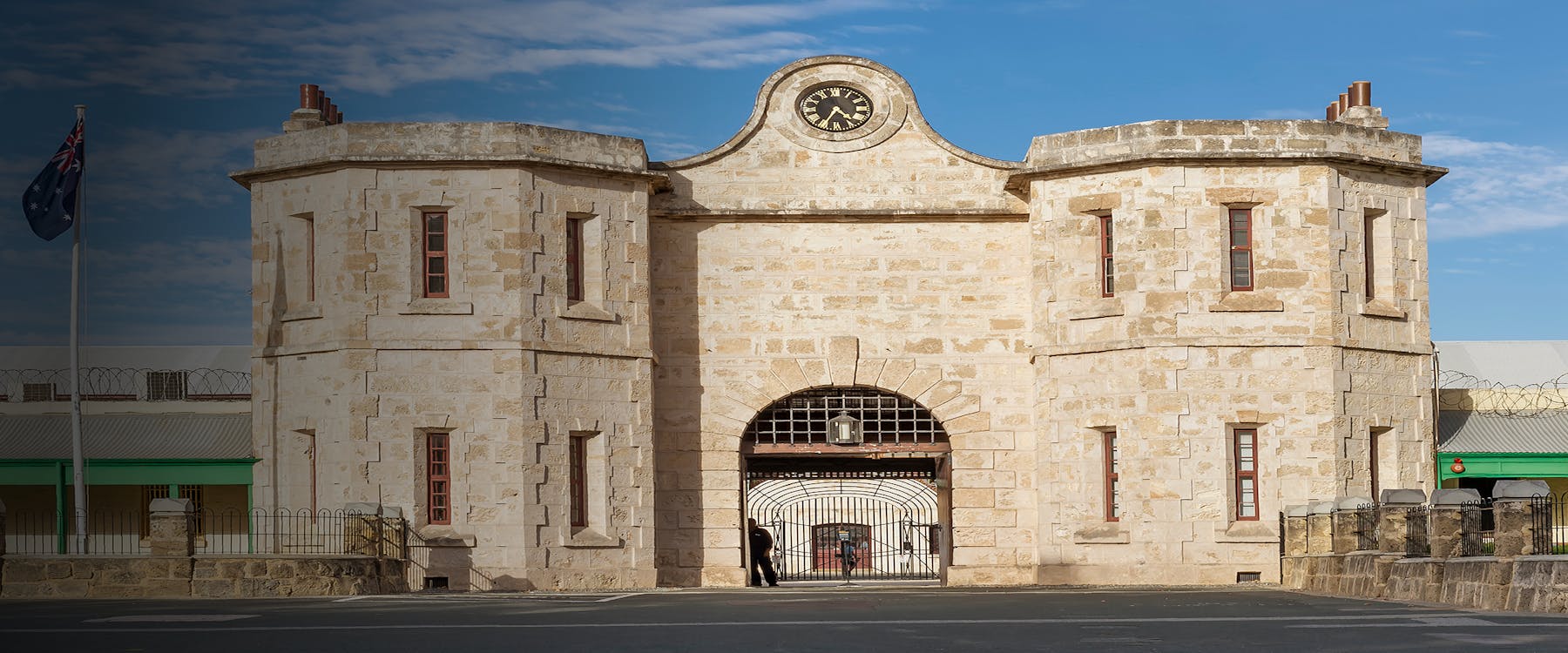 Fremantle Prison entrance with Australian flag, sunny day, Western Australia.